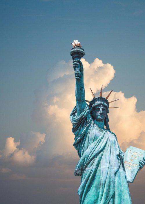 Iconic Statue of Liberty with majestic clouds in New York, USA. Perfect travel destination image.